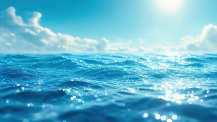 Ocean waves under a bright blue sky with fluffy clouds and sunlight.