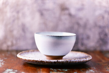 Traditional japanese ceramic on rustic wooden background. Soft focus. Copy space.	