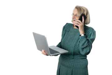 Senior woman multitasking, talking on phone, using laptop