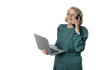 Senior woman multitasking, talking on phone, using laptop