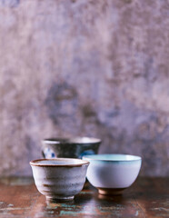Traditional japanese ceramic on rustic wooden background. Soft focus. Copy space.	