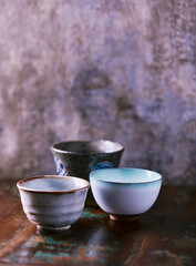 Traditional japanese ceramic on rustic wooden background. Soft focus. Copy space.	