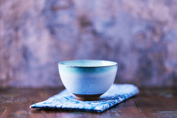 Traditional japanese ceramic on rustic wooden background. Soft focus. Copy space.	