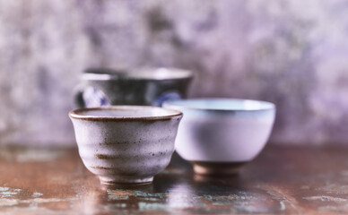 Traditional japanese ceramic on rustic wooden background. Soft focus. Copy space.	