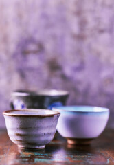Traditional japanese ceramic on rustic wooden background. Soft focus. Copy space.	