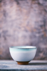 Traditional japanese ceramic on rustic wooden background. Soft focus. Copy space.	