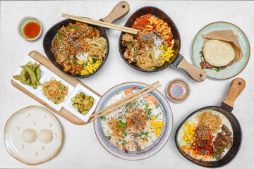 Assortiment de plats chinois : bao, bouchées, bouillons, nouilles, burger chinois et perles de coco – vue 90°