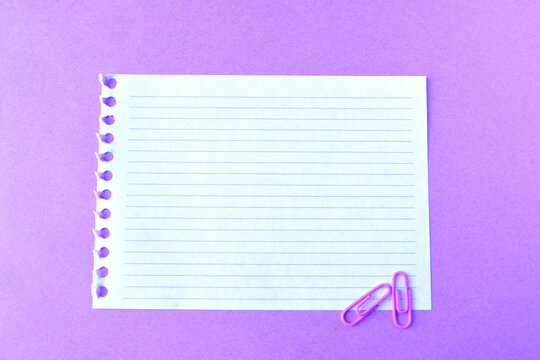 Clean lined paper sheet on a bright purple background. Space for text. - Powered by Adobe