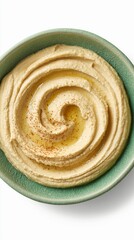 Close-up of hummus in a green plate isolated on a white background