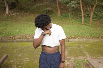 Naklejka premium A lone African man exercising in the park 