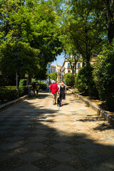 Mature couple strolling hand in hand in medieval city of seville spain