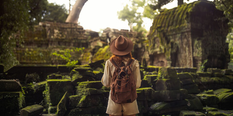 Woman Traveler Facing Mossy Angkor Jungle Temple Ruins Panorama Banner