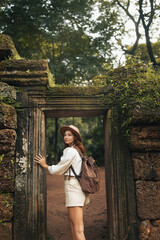 Female Traveler At Ancient Jungle Temple Gate In Historic Cambodia Ruins