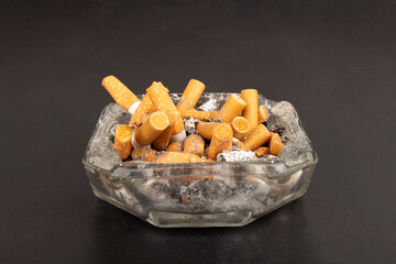 cigarette butts torn on black background ashtray