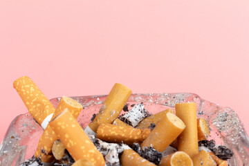 cigarette butts torn on pink background ashtray