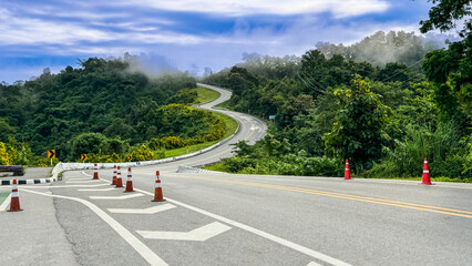 The road is similar to the number 3. This road is built past the forest. It is a famous or popular place where tourists come to take pictures as souvenirs in Nan province, Thailand.