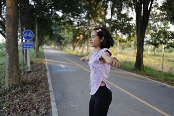 Woman exercises before running at morning.