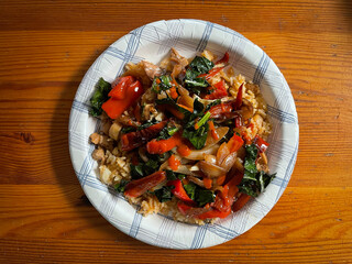 Healthy vegetarian meal on a paper plate an wood table