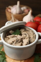 Tasty beef stroganoff with parsley served on wooden table, closeup