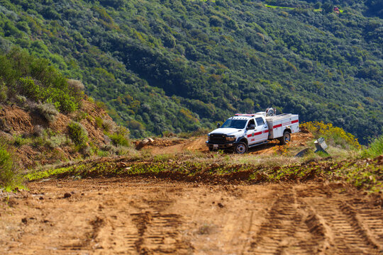 Los Angeles, California - December 4, 2025: White Fire Utility Truck on Dirt Trail in Calabasas Park Mountains