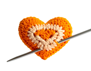 Orange crocheted heart, cream design, pierced by knitting needle