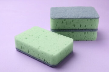 Clean kitchen sponges on violet background, closeup