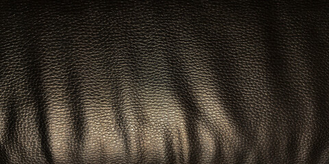 Close-up, high-resolution texture of deep brown, lightly-tumbled faux or genuine leather. Surface has fine natural grain with subtle wrinkles and creases, illuminated from above to create a glossy