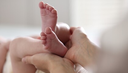 Mother with her cute newborn baby indoors, closeup
