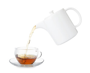 Pouring hot tea into cup from teapot on white background