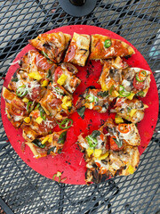 Homemade pizza made on a grill in the back yard