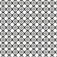 Intricate black and white geometric quatrefoil pattern repeating seamlessly across a textured surface