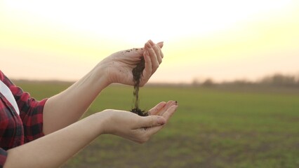 The agronomist checks the nutritional value of the soil of the land, fertilized and plowed field, the farmer works in the open air, the life of a collective farmer in the countryside, 4K.