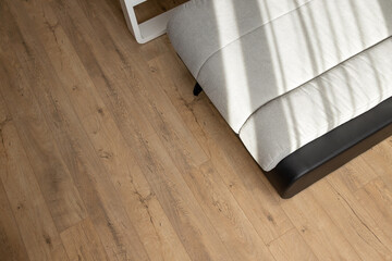 Natural wood laminate parquet floor. Room with floating laminate in new apartmen.  Cozy home...