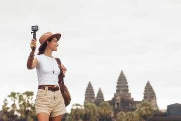 Female Tourist Filming Travel Vlog at Angkor Wat Temple in Cambodia