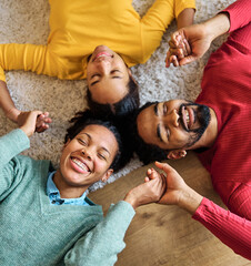 Portrait of mother, father and daughter having fun at home, family life, parenting, love and bonding concepts