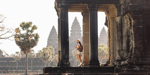 Angkor Wat Columns With Female Backpacker, Iconic Khmer Temple View