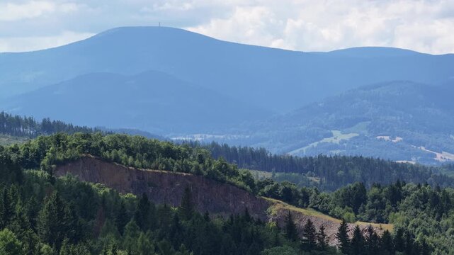 Aerial drone summer panoramic view of Ladek Zdroj town nestled in scenic Klodzko Valley Poland, surrounded by lush greenery and rolling hills of the Golden Mountains