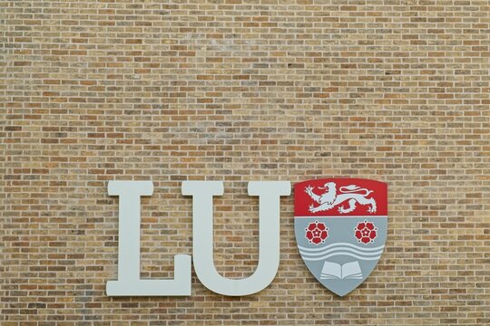 LANCASTER, LANCASHIRE, ENGLAND - JULY 17, 2025 : Close up of Lancaster University (LU) coat of arms official logo. LU was founded in 1964 by royal charter among other universities created in the 1960s