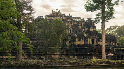 Baphuon Temple Ruins In Angkor Thom Framed By Trees, Cambodia Travel