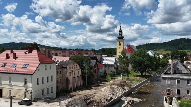 Aerial drone summer panoramic view of Ladek Zdroj town nestled in scenic Klodzko Valley Poland, surrounded by lush greenery and rolling hills of the Golden Mountains