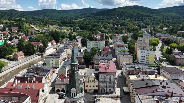 Aerial drone summer panoramic view of Ladek Zdroj town nestled in scenic Klodzko Valley Poland, surrounded by lush greenery and rolling hills of the Golden Mountains