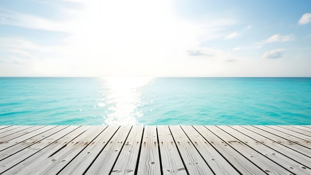 Wooden deck overlooking turquoise ocean with bright sunlight and blue sky