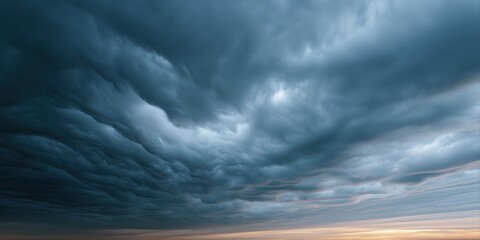 Dramatic storm clouds in a dramatic sky with sunset on the horizon