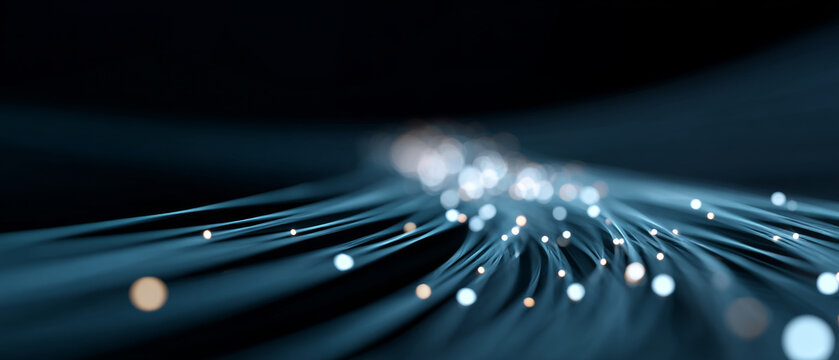 Abstract close-up of glowing fiber optic cables with blue light trails and bokeh effect on dark background