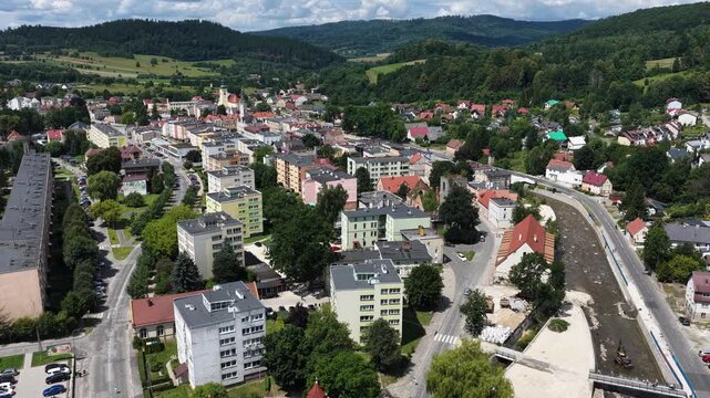 Aerial drone summer panoramic view of Ladek Zdroj town nestled in scenic Klodzko Valley Poland, surrounded by lush greenery and rolling hills of the Golden Mountains