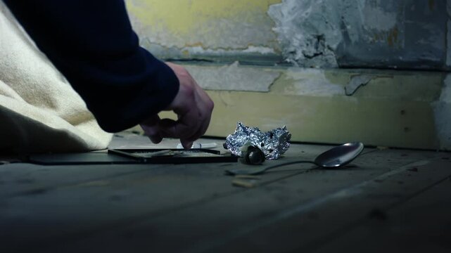 Addict cutting Illegal drugs in abandoned house