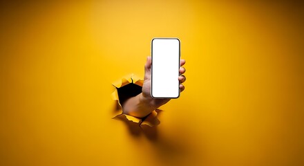 Breakthrough mobile app concept with hand holding phone through vibrant yellow paper, blank screen for customization, modern technology advertisement, dynamic