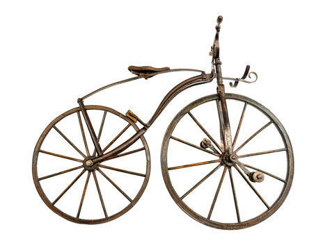 A historical bicycle, boneshaker, 19th century, isolated on white background