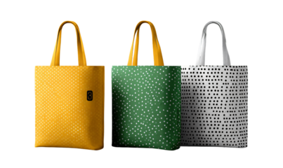 Three colorful polka dot tote bags on transparent background