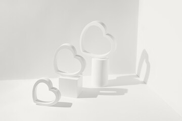 Creative composition made of heart shaped figures and geometric podiums. Valentine day and romance concept. Minimal style. Color of the year 2026 inspired